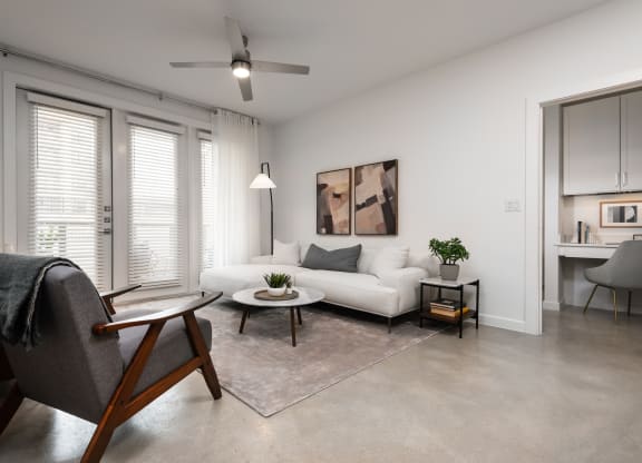 a living room with a white couch and a chair
