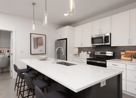an open kitchen with a large white counter top