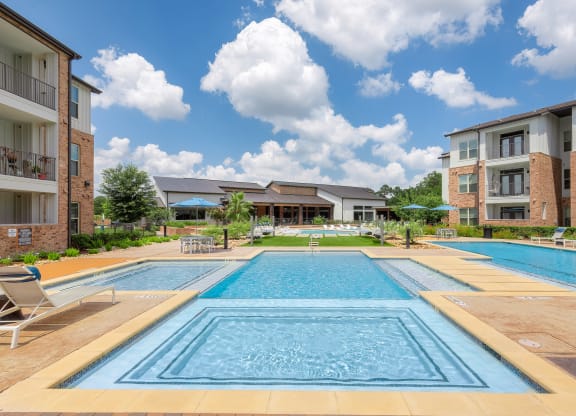 apartments with a swimming pool in front of a building