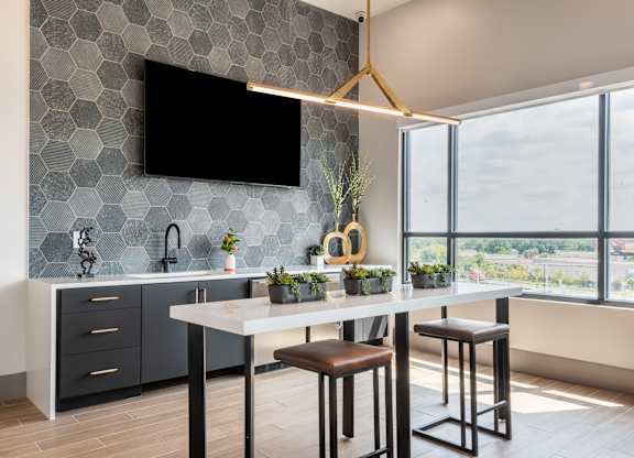 A modern kitchen with a bar stool and a countertop.