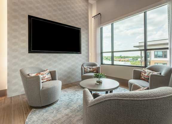 A living room with a television and comfortable seating.