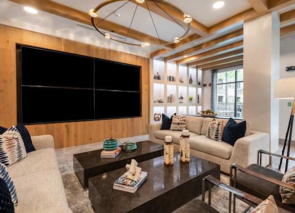 A modern living room with a wooden wall and a blackboard.