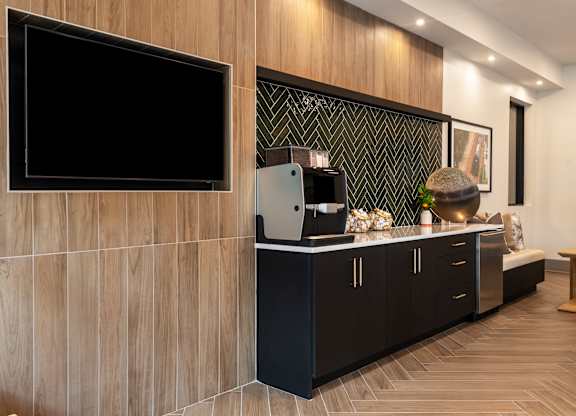 A modern kitchen with dark wood cabinets and a black countertop.