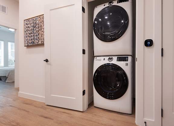 A white washing machine is in a doorway.