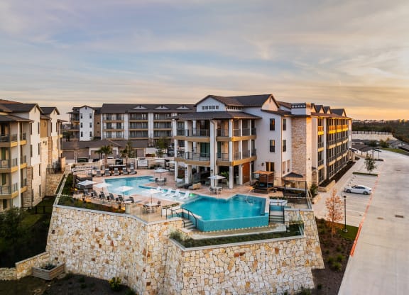 an aerial view of an apartment building with a swimming pool