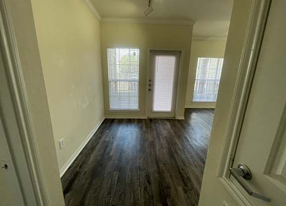 A room with wooden floors and white walls.