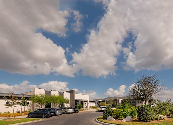 A large building with a parking lot in front of it.