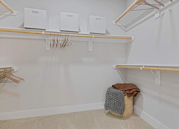 A white closet with a hanging rod and shelves.