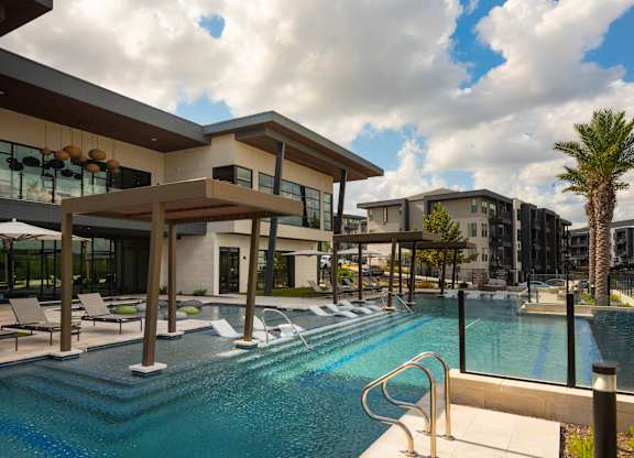A swimming pool in front of a modern building.