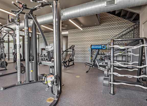 A gym with a variety of equipment including a leg press machine.