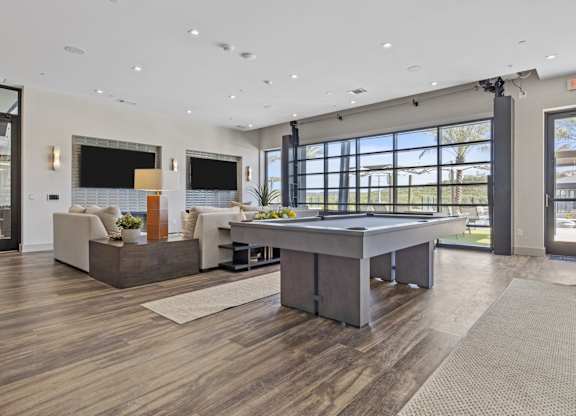 A spacious living room with a large table and a couch.
