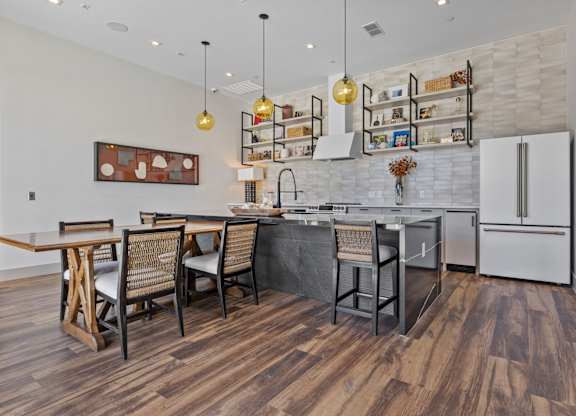 A kitchen with a wooden floor and white walls.