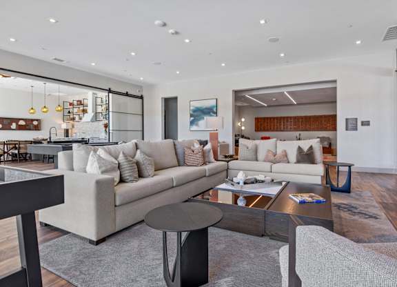 A modern living room with a grey sofa and a coffee table.