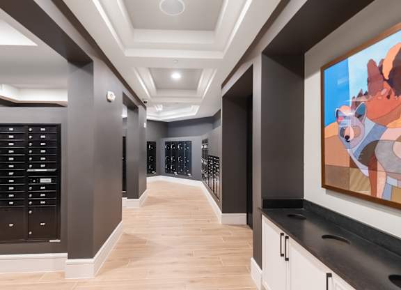 A hallway with a large painting of a bear on the wall.