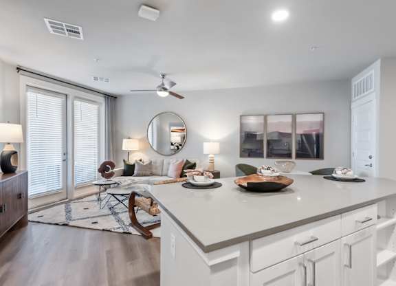 A modern kitchen with a large island and a dining area.