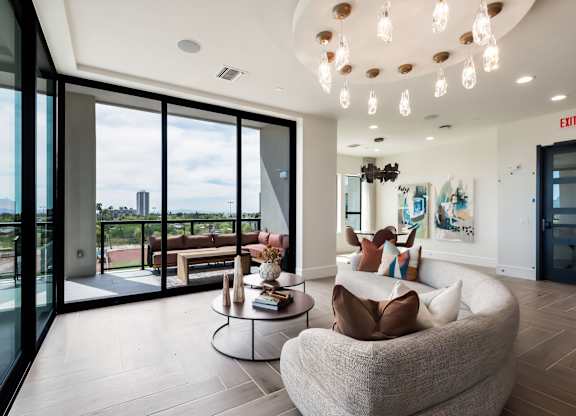 A modern living room with a large window overlooking the city.