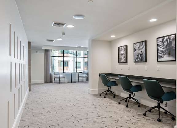 A conference room with a long table and chairs.