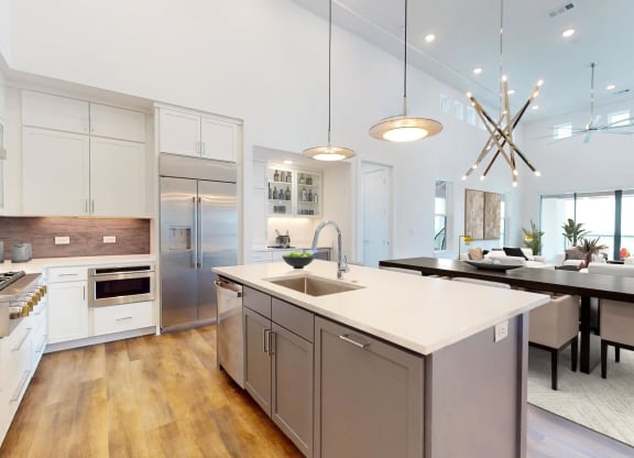 a large kitchen with an island and a dining table