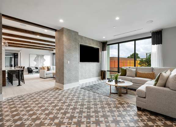 a living room filled with furniture and a large window