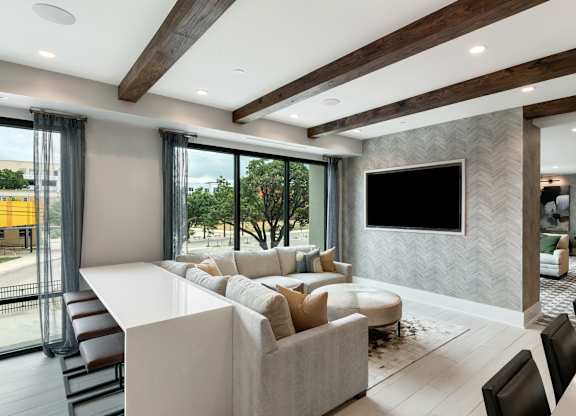 a living room filled with furniture and a large flat screen tv