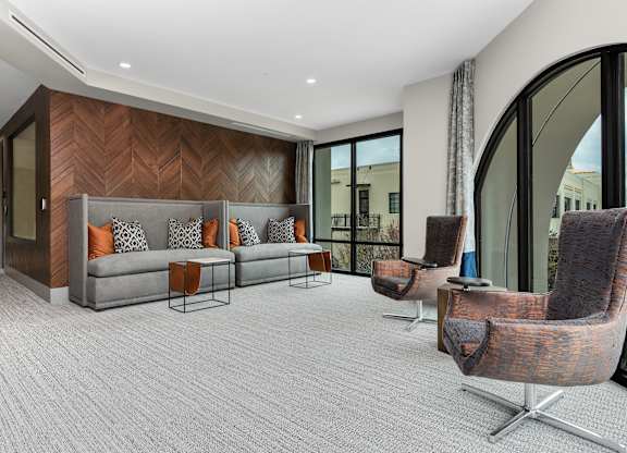 a living room with a couch and chairs