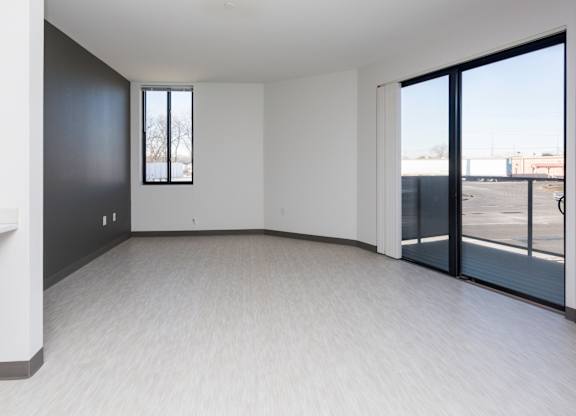 Spacious living room with neutral walls and ample natural light.