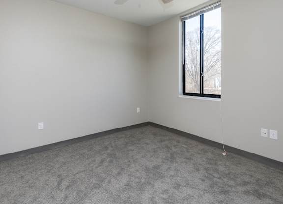 Spacious living room with neutral walls and ample natural light.