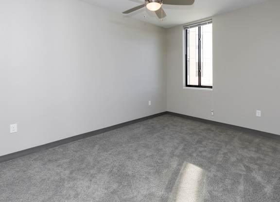 Spacious living room with neutral walls and ample natural light.