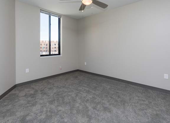 Spacious living room with neutral walls and ample natural light.