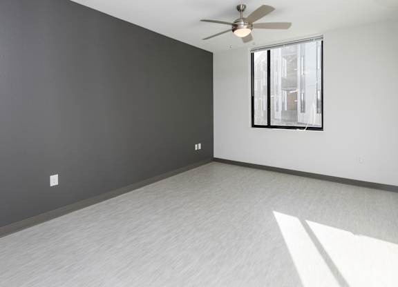 Bright, vacant bedroom with neutral walls and carpet flooring.