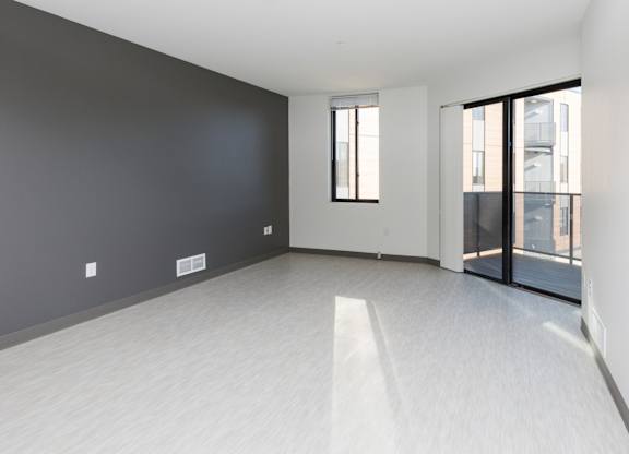 Spacious living room with neutral walls and ample natural light.