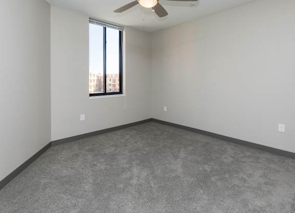 Spacious living room with neutral walls and ample natural light.