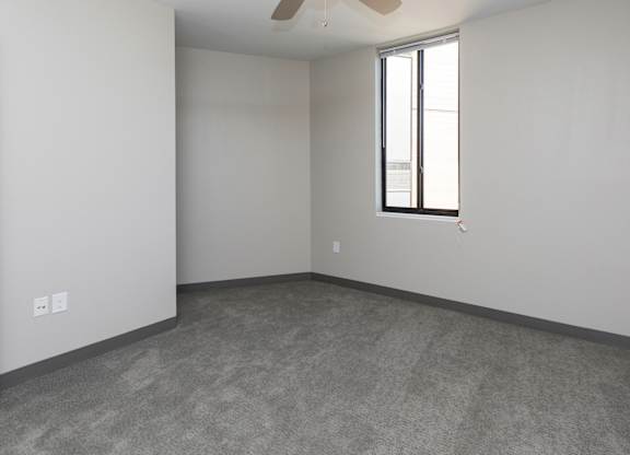 Spacious living room with neutral walls and ample natural light.