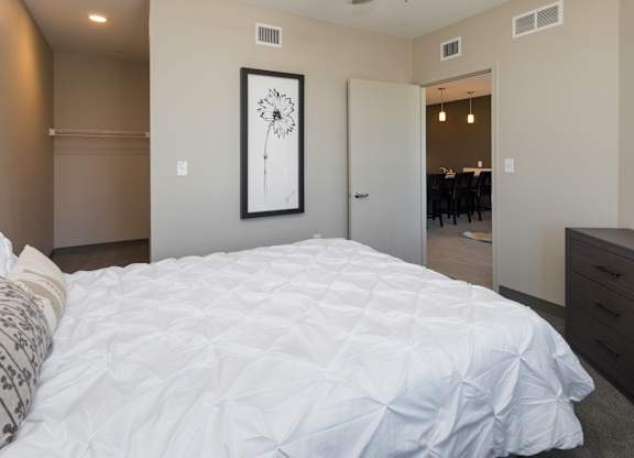 Bright, vacant bedroom with neutral walls and carpet flooring.