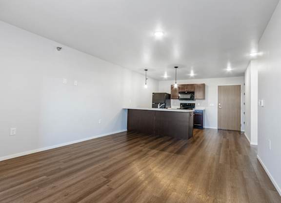 A kitchen with a wooden floor and a counter.