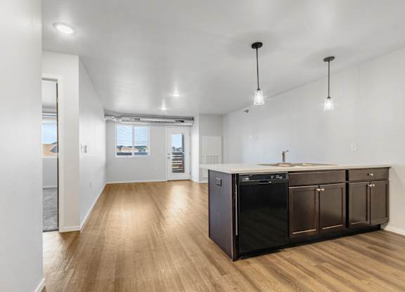 A kitchen with dark wood cabinets and a white countertop.
