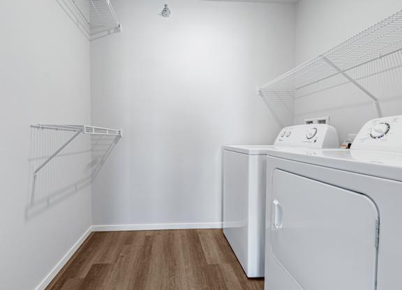 A white laundry room with a washer and dryer.