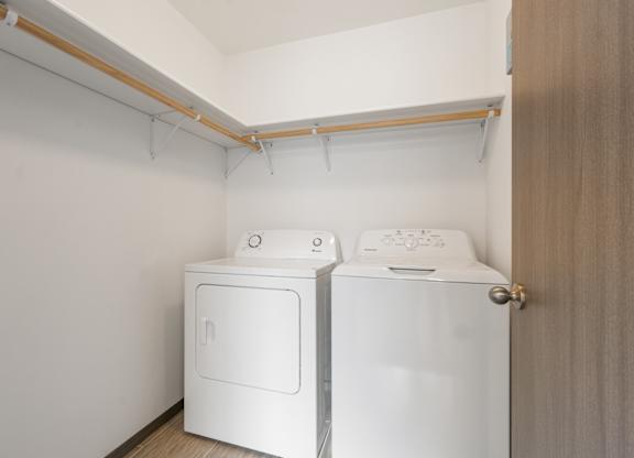 A small laundry room with a washer and dryer.
