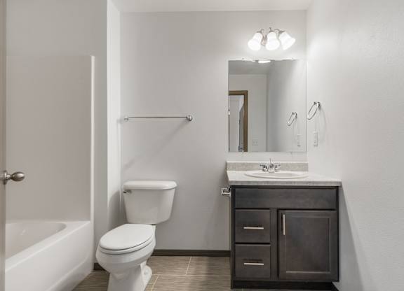 A white toilet sits next to a sink in a bathroom.