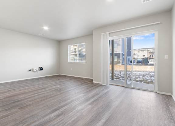 A room with a sliding glass door leading to a balcony.