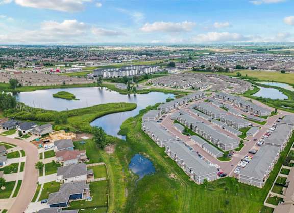 A bird's eye view of a residential area with houses and a river.