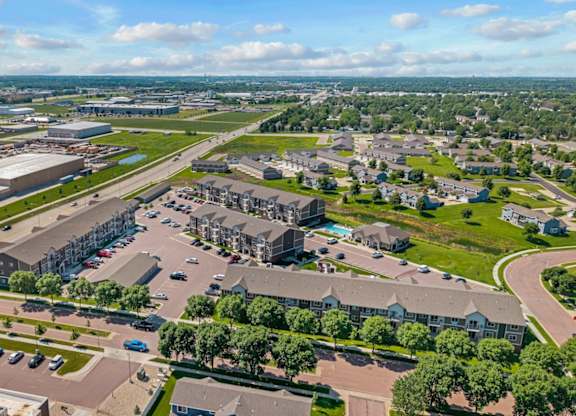 A large aerial view of a city with a mix of buildings and green spaces.