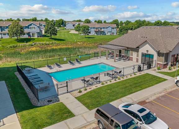 A large house with a pool in the backyard.