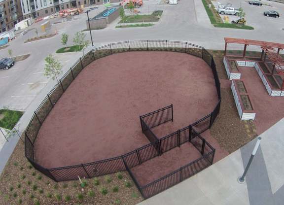 Fenced dog park with agility equipment.