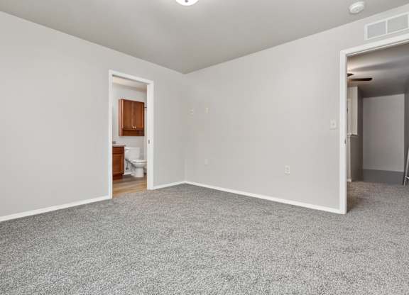 A room with a carpeted floor and white walls.