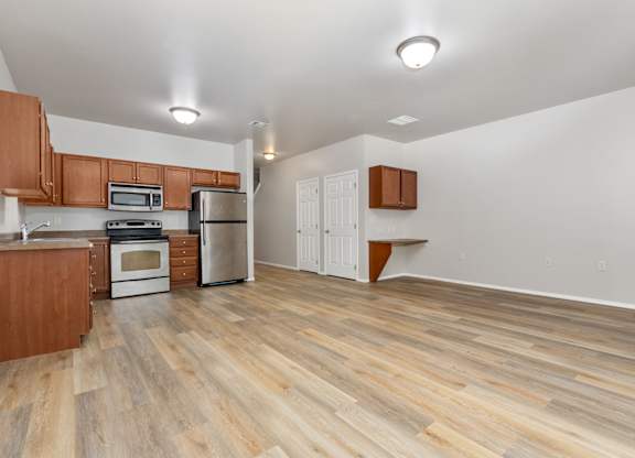 A kitchen with wooden floors and white walls.
