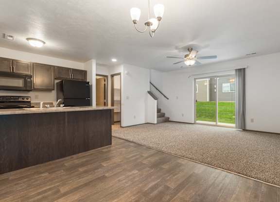 A spacious living room with a staircase leading to the upper floor.