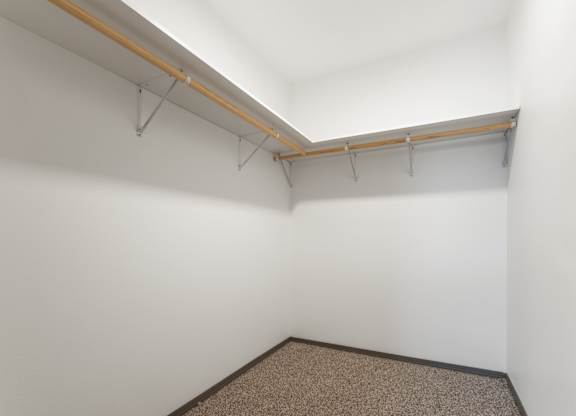 A room with a white wall and a brown carpet.
