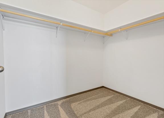 A room with a door and a carpet on the floor.