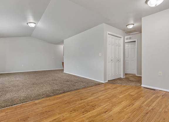 A room with wooden floors and white walls.